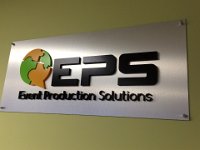 Brushed silver panel with 3D lettering installed on the wall with standoffs